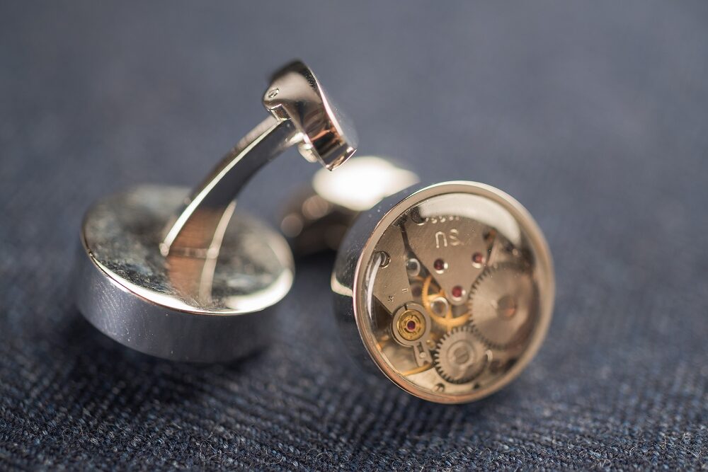 Round cufflinks with watch movements with lens