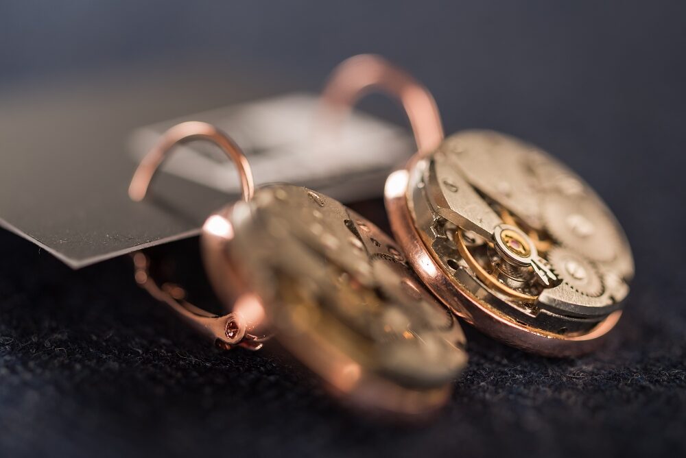 Earrings with watch movements in rose gold colour frames