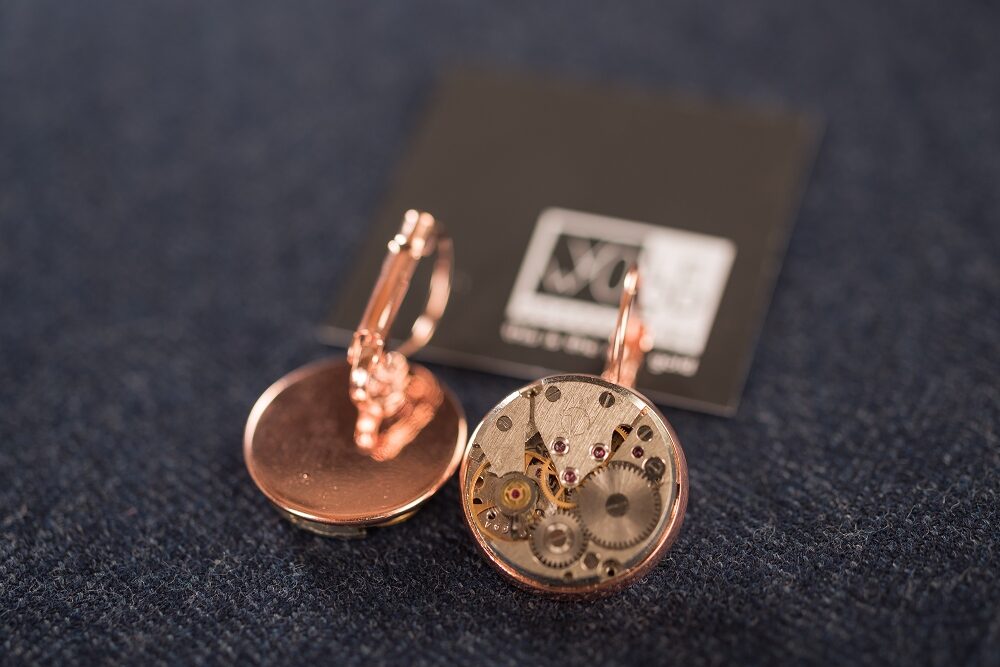 Earrings with watch movements in rose gold colour frames