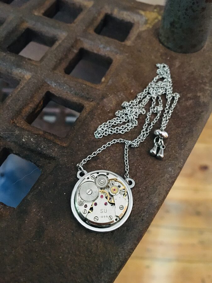 Necklace with watch movement with adjustable chain