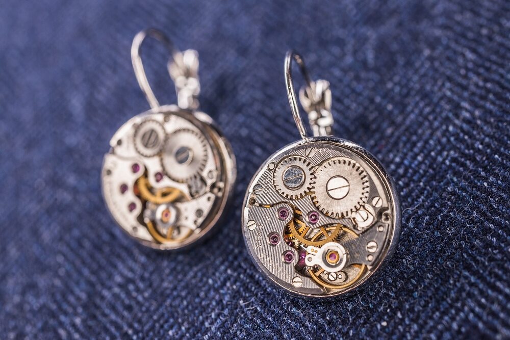 Earrings with watch movements in silver colour frames