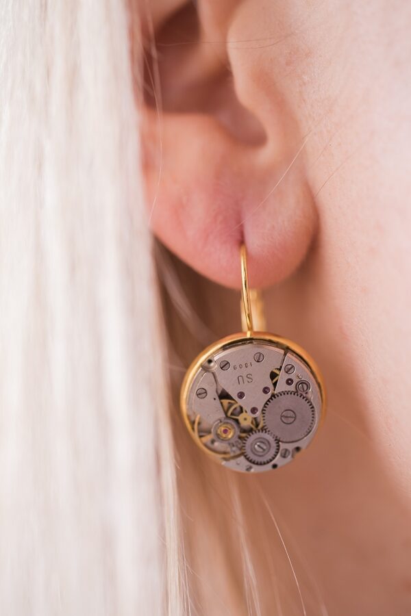 Earrings with watch movements in gold colour frames