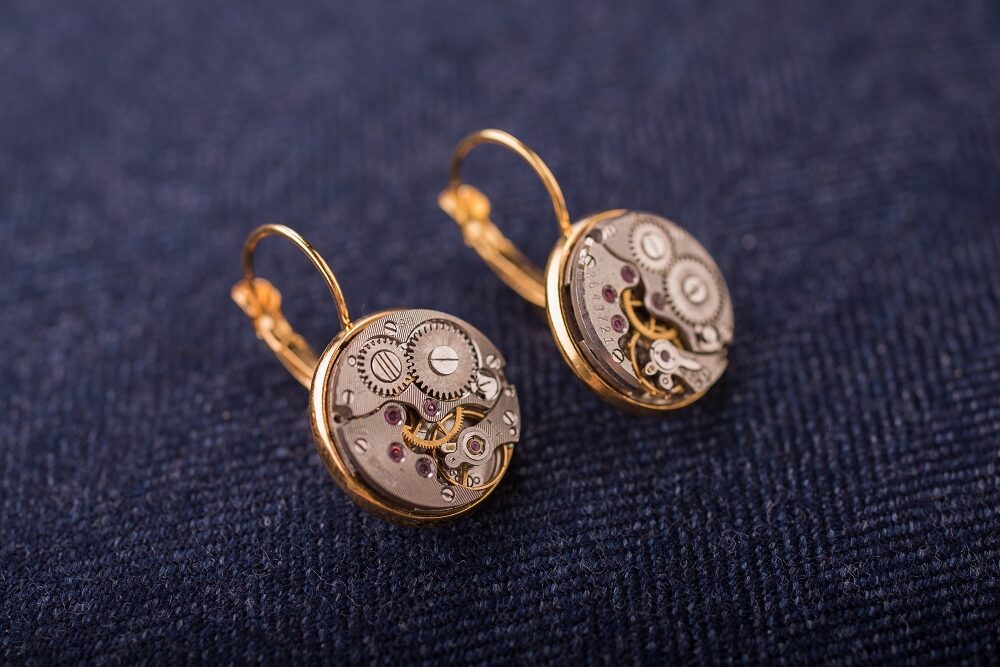Earrings with watch movements in gold colour frames