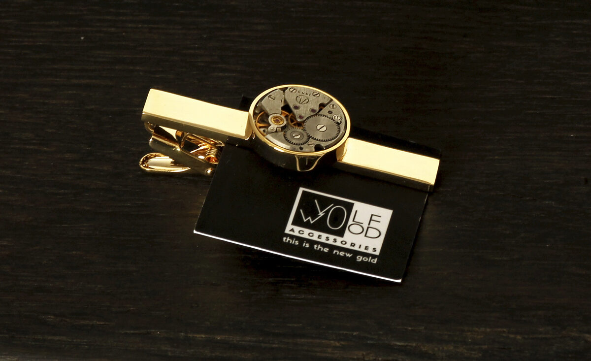 Tie clip with a round watch movement