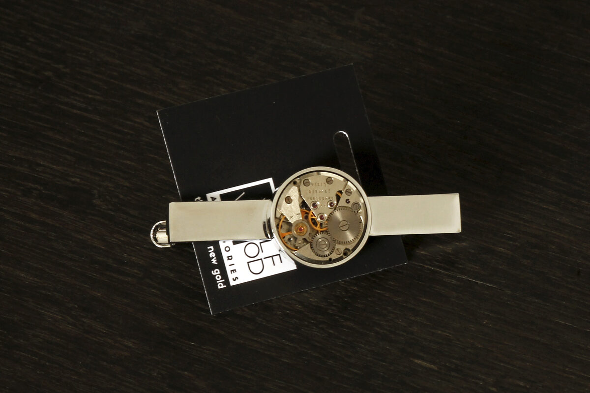 Tie clip with a round watch movement